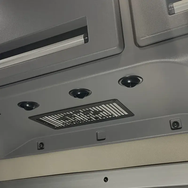 Integrated evaporator system, vents and a grille built into a truck cab headliner